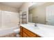 Bathroom features a vanity with a large mirror and a shower-tub combo with storage at 4751 Kemp Dellinger Rd, Maiden, NC 28650