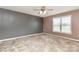 Comfortable bedroom featuring neutral walls, carpet, a ceiling fan, and a bright window at 4751 Kemp Dellinger Rd, Maiden, NC 28650