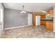 Dining area featuring neutral walls, tile flooring, a chandelier, and access to the kitchen at 4751 Kemp Dellinger Rd, Maiden, NC 28650