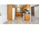 Functional kitchen featuring oak cabinets, tile floors, a refrigerator, and standard appliances at 4751 Kemp Dellinger Rd, Maiden, NC 28650