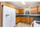 Functional kitchen featuring oak cabinets, tile floors, a refrigerator, and standard appliances at 4751 Kemp Dellinger Rd, Maiden, NC 28650