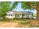Charming single-story home with a well-maintained front yard and mature trees at 4838 Holbrook Dr, Charlotte, NC 28212