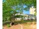 Charming home with a well-manicured lawn, a tree swing, and a quaint front porch with beautiful flower pots at 4838 Holbrook Dr, Charlotte, NC 28212