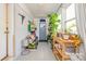 Bright sunroom-style hallway with plants and an exterior door at 4838 Holbrook Dr, Charlotte, NC 28212