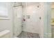 Luxurious walk-in shower with white marble walls and a gray tile floor at 4838 Holbrook Dr, Charlotte, NC 28212