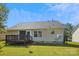 Exterior view of the backyard, featuring a back deck and a well-maintained lawn at 5018 Drake Pond Ln, Rock Hill, SC 29732