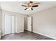 A simple bedroom with gray floors, a ceiling fan, a closet, and fresh paint at 5018 Drake Pond Ln, Rock Hill, SC 29732
