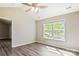 Inviting bedroom with a bright window, hardwood flooring, and neutral color scheme at 5018 Drake Pond Ln, Rock Hill, SC 29732