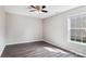 Bright bedroom featuring a ceiling fan, neutral paint, gray floors and a window providing ample natural light at 5018 Drake Pond Ln, Rock Hill, SC 29732