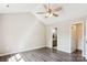 Cozy bedroom boasts a ceiling fan, hardwood floors, and ensuite bathroom at 5018 Drake Pond Ln, Rock Hill, SC 29732