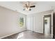 Clean bedroom with updated gray floors, a ceiling fan, and a closet for added storage at 5018 Drake Pond Ln, Rock Hill, SC 29732