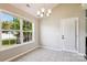 Bright dining area with tiled floors, a modern chandelier, and a large window with a backyard view at 5018 Drake Pond Ln, Rock Hill, SC 29732