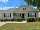 Charming single-story home with a well-manicured lawn and inviting front porch, perfect for relaxation at 5018 Drake Pond Ln, Rock Hill, SC 29732