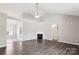 Open-concept living room with hardwood floors, fireplace, and access to kitchen at 5018 Drake Pond Ln, Rock Hill, SC 29732