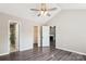Bedroom with a ceiling fan, wood floors, and doors to a bathroom, closet, and living room at 5018 Drake Pond Ln, Rock Hill, SC 29732