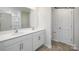 Well-lit bathroom featuring a double vanity with modern fixtures and a framed mirror above, complemented by neutral flooring at 547 Trading Post Ln, York, SC 29745