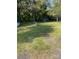 A serene backyard features a lush lawn, shade trees, and inviting outdoor seating at 642 Boger St, Mooresville, NC 28115