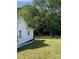 Spacious backyard with lush greenery and a glimpse of the side of the white house at 642 Boger St, Mooresville, NC 28115