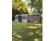 Backyard featuring two storage sheds, lawn, and mature shade trees, perfect for outdoor activities at 642 Boger St, Mooresville, NC 28115