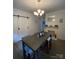 A dining area showcases a modern table, stylish chandelier, and elegant barn door at 642 Boger St, Mooresville, NC 28115