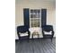 Cozy front porch seating area with wicker chairs, a table, and string lights for a relaxing outdoor space at 642 Boger St, Mooresville, NC 28115