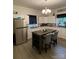 Modern kitchen with a large island, stainless steel appliances, and a stylish chandelier for a sophisticated look at 642 Boger St, Mooresville, NC 28115