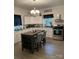 Modern kitchen with a large island, stainless steel appliances, and a stylish chandelier for a sophisticated look at 642 Boger St, Mooresville, NC 28115