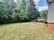 Spacious backyard with a deck and staircase; surrounded by mature trees at 668 Osteen Rd, York, SC 29745