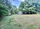 Lush backyard with trees and vegetation in the distance at 668 Osteen Rd, York, SC 29745