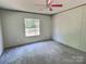 Bedroom with plain walls, a window offering natural light, and bare floors create a minimalist atmosphere at 668 Osteen Rd, York, SC 29745