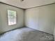 Bedroom with bare floors, a single window offering natural light, and neutral walls, providing a blank canvas at 668 Osteen Rd, York, SC 29745