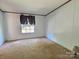 Bedroom with neutral carpet, simple window coverings and ample natural light creates a calm, relaxing atmosphere at 668 Osteen Rd, York, SC 29745