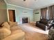 Cozy living room with fireplace, neutral carpet, and comfortable seating, perfect for relaxing and entertaining at 668 Osteen Rd, York, SC 29745