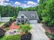 Aerial view of a lovely home featuring mature trees, impeccable landscaping, and a spacious driveway at 7710 Grove Hall Ave, Mint Hill, NC 28227