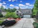 Aerial view of a single-story home with a large driveway and professionally landscaped front yard at 7710 Grove Hall Ave, Mint Hill, NC 28227