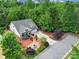 Aerial view of a home that boasts a large yard with mature trees and a long driveway at 7710 Grove Hall Ave, Mint Hill, NC 28227
