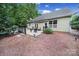 Relaxing backyard with concrete patio and awning features an outdoor seating area perfect for entertaining at 7710 Grove Hall Ave, Mint Hill, NC 28227