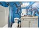 A unique bathroom featuring blue walls with a whimsical octopus design and neutral-toned vanity at 7710 Grove Hall Ave, Mint Hill, NC 28227