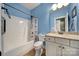 Bathroom features a shower-tub combo, toilet, and vanity with granite countertop at 7710 Grove Hall Ave, Mint Hill, NC 28227