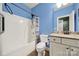 Bathroom featuring a shower-tub combo, granite vanity, and neutral decor at 7710 Grove Hall Ave, Mint Hill, NC 28227