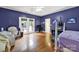 A bedroom with wood floors, filled with furniture, and a door to the outside at 7710 Grove Hall Ave, Mint Hill, NC 28227