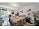 A tidy bedroom with neutral walls, hardwood floors, decorative bedding and a window with a view at 7710 Grove Hall Ave, Mint Hill, NC 28227