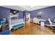 Large bedroom featuring hardwood floors, a white bed frame, and seating bench at 7710 Grove Hall Ave, Mint Hill, NC 28227