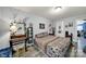 A cozy bedroom with hardwood floors, and a desk with a makeup mirror and stool at 7710 Grove Hall Ave, Mint Hill, NC 28227