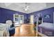 Bright bedroom with french doors, hardwood floors, and a ceiling fan at 7710 Grove Hall Ave, Mint Hill, NC 28227