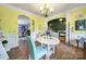 Bright dining room with hardwood floors offering a view to the kitchen and foyer at 7710 Grove Hall Ave, Mint Hill, NC 28227