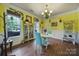 Bright dining room with hardwood floors, charming decor, and lots of natural light at 7710 Grove Hall Ave, Mint Hill, NC 28227
