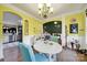 Bright dining area with cheerful yellow walls, archways, and decorative wainscoting at 7710 Grove Hall Ave, Mint Hill, NC 28227