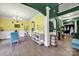 Bright dining room with chandelier, decorative wainscoting, and a unique color scheme creating a cheerful atmosphere at 7710 Grove Hall Ave, Mint Hill, NC 28227