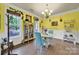 Charming dining area featuring a display case, large windows, and cheerful yellow walls at 7710 Grove Hall Ave, Mint Hill, NC 28227